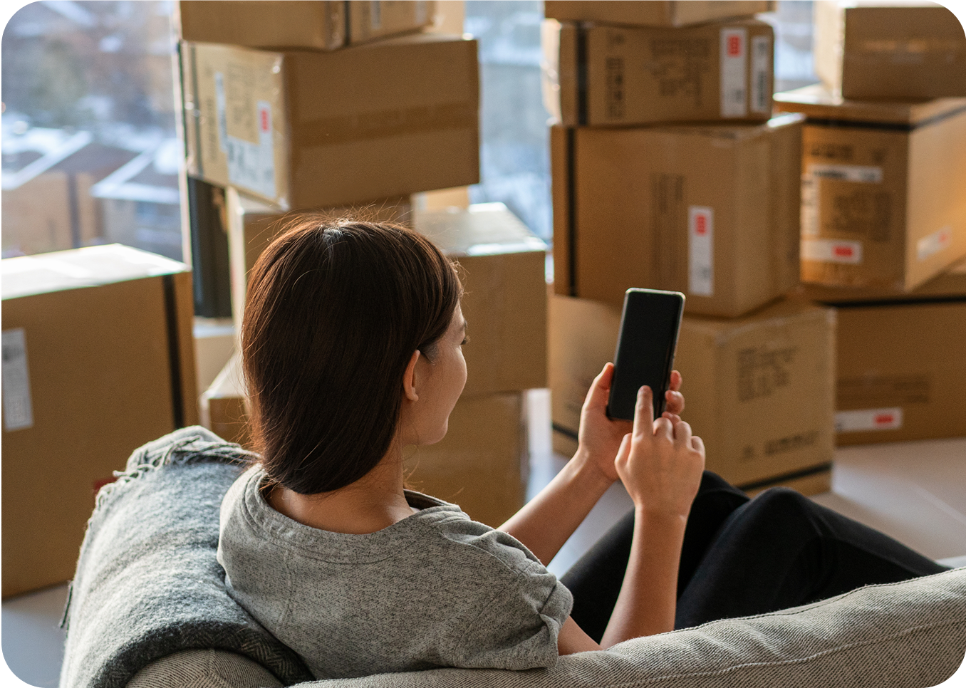 Person using phone with boxes