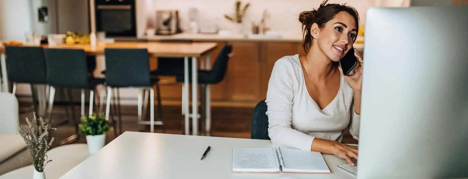 Woman on the phone talking to her utility providers to change her address.