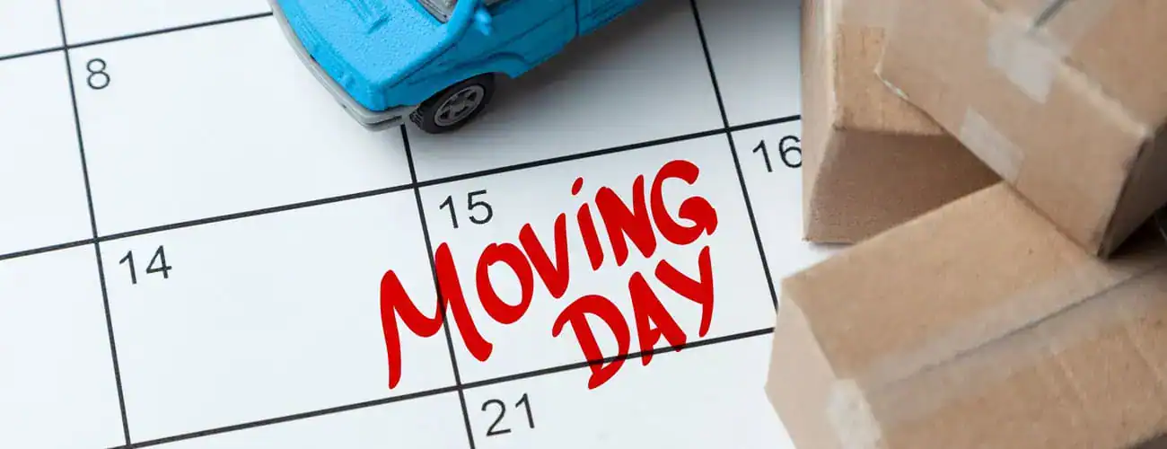 Moving boxes, a moving truck, and a calendar indicating when moving day is