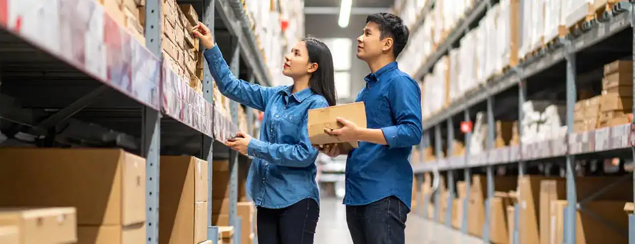 A man and a woman shopping for boxes at a hardware store